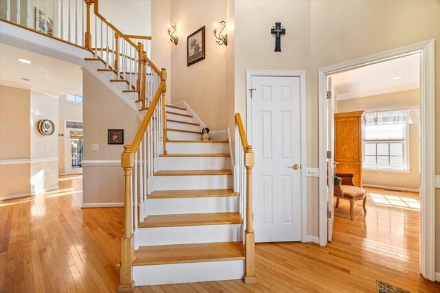 102 Shawn Cir, Staunton, VA 24401 - stairway with baseboards, crown molding, a towering ceiling, and hardwood / wood-style flooring