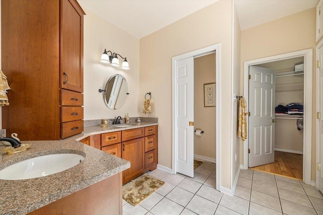 102 Shawn Cir, Staunton, VA 24401 - full bathroom featuring vanity, a walk in closet, baseboards, and tile patterned floors