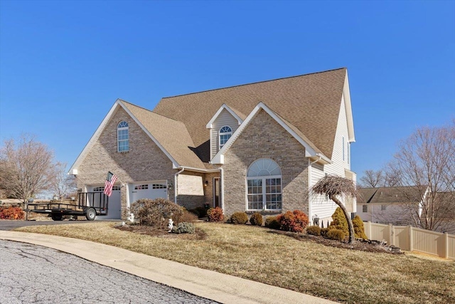 102 Shawn Cir, Staunton, VA 24401 - traditional home with driveway, brick siding, fence, a front yard, and roof with shingles