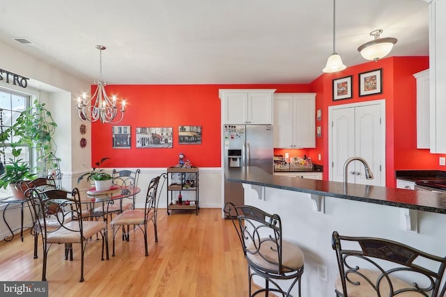 514 Lakeview Pkwy, Locust Grove, VA 22508 - kitchen featuring a breakfast bar, white cabinetry, dark countertops, and a sink