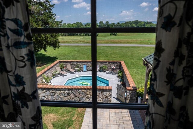 view of pool featuring a yard and a patio area