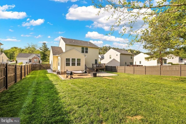 back of house with a lawn, a patio, a residential view, and a fenced backyard