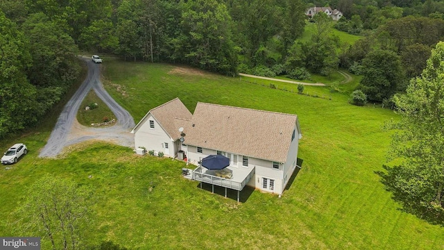 view from above of property with a heavily wooded area