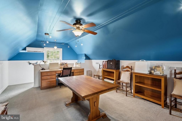 carpeted office space with ceiling fan and lofted ceiling