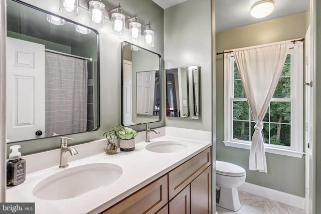 10101 Westover Ct, Fredericksburg, VA 22408 - full bathroom featuring toilet, double vanity, marble finish floors, and baseboards