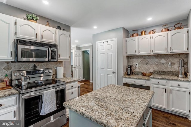 10101 Westover Ct, Fredericksburg, VA 22408 - kitchen featuring stainless steel appliances, decorative backsplash, white cabinetry, and recessed lighting