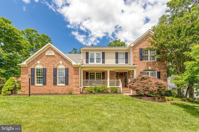 10101 Westover Ct, Fredericksburg, VA 22408 - view of front of property featuring covered porch, a front yard, and brick siding