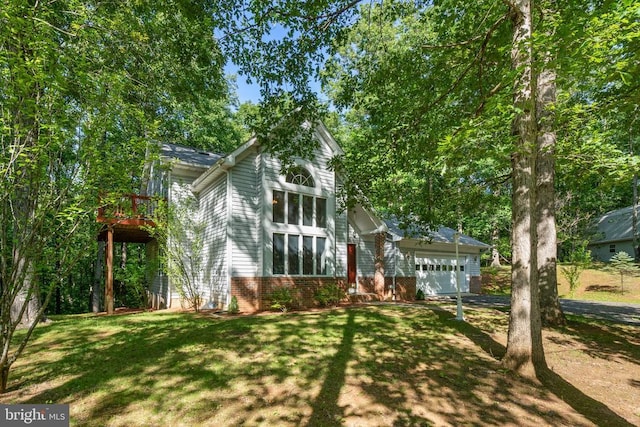 - view of front facade with an attached garage and a front yard