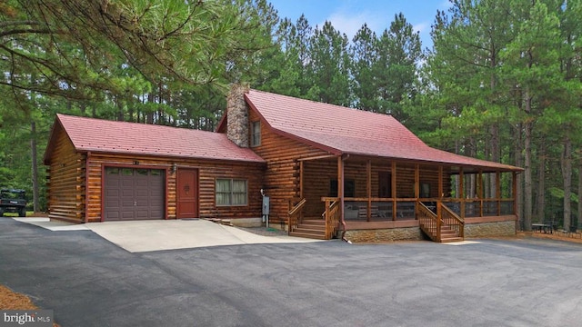 362 Dell Perkins Rd, Louisa, VA 23093 - log cabin featuring covered porch, a chimney, driveway, log siding, and an attached garage