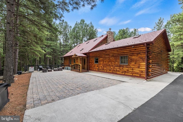362 Dell Perkins Rd, Louisa, VA 23093 - rear view of property featuring a patio area, log exterior, and a chimney