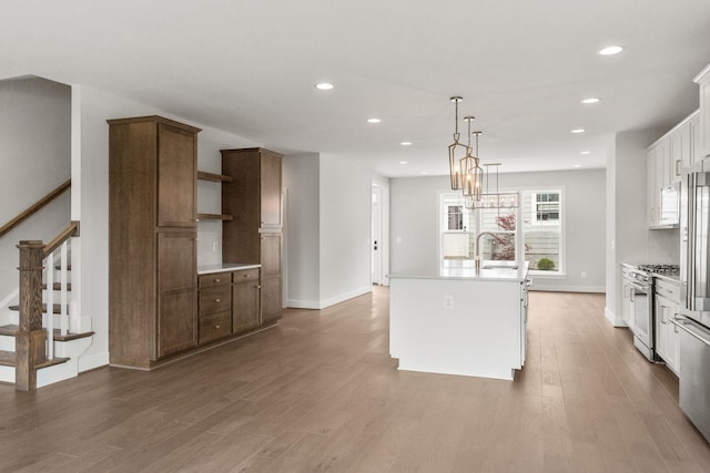 3251 Preston Shore Dr Unit 18E, Rockingham, VA 22801 - kitchen featuring stainless steel range, recessed lighting, a center island with sink, wood finished floors, and light countertops