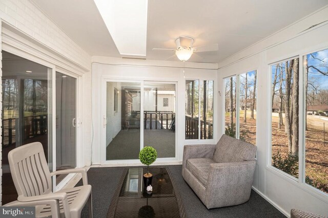 sunroom featuring ceiling fan and healthy amount of natural light