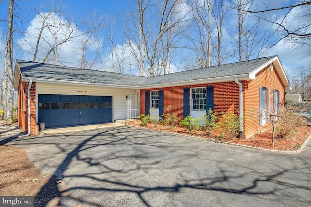 ranch-style house with asphalt driveway, brick siding, an attached garage, and roof with shingles