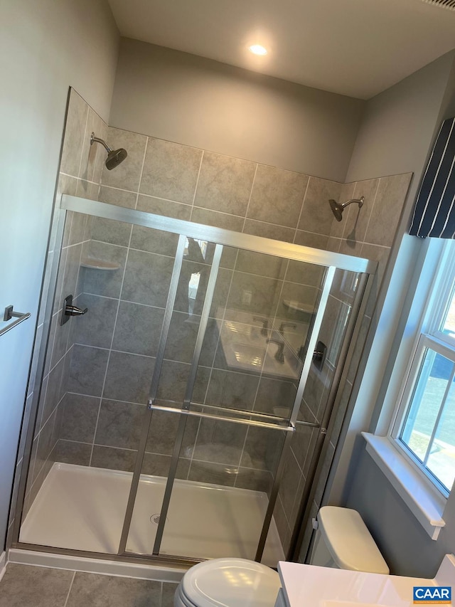 full bathroom featuring tile patterned floors, toilet, a stall shower, and vanity