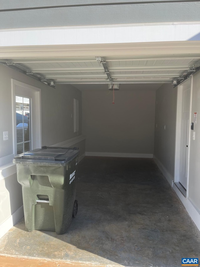 garage featuring baseboards and a garage door opener