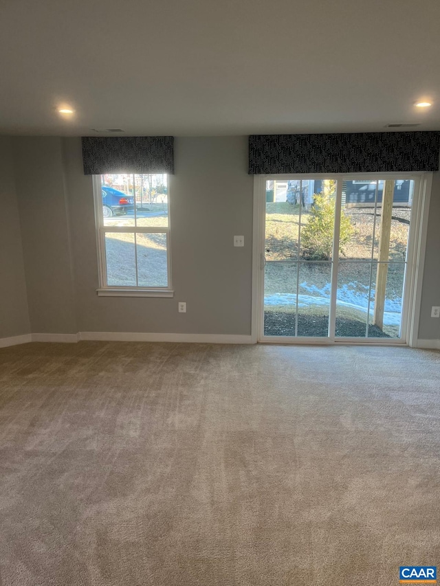 carpeted empty room with baseboards and recessed lighting