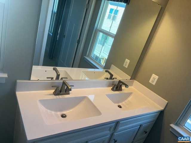 bathroom with a sink and double vanity