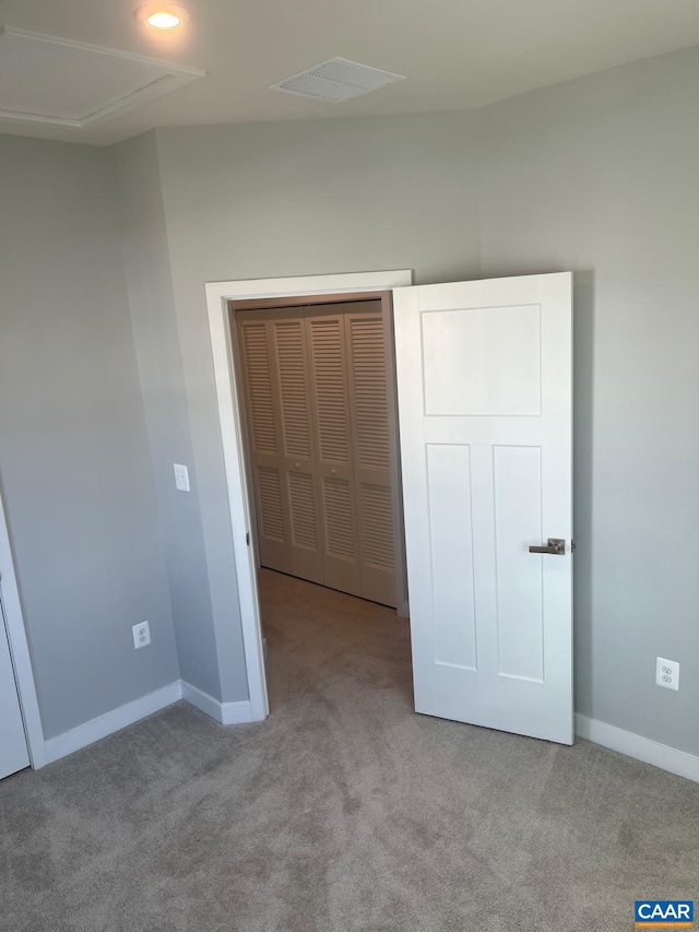 unfurnished bedroom featuring carpet flooring, visible vents, and baseboards