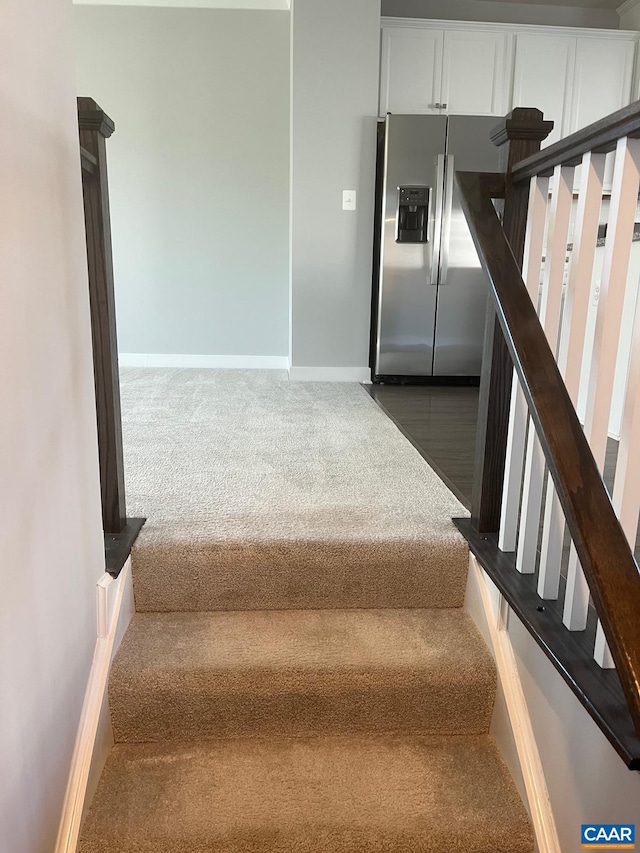 stairway with carpet and baseboards