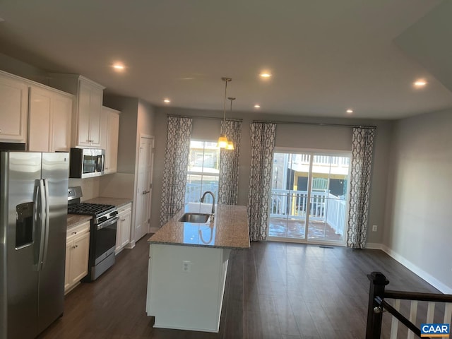 kitchen with a wealth of natural light, dark wood finished floors, appliances with stainless steel finishes, and a sink