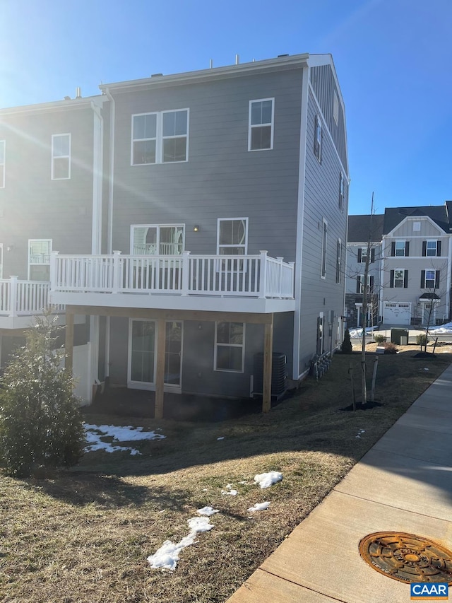 back of property featuring a deck and cooling unit