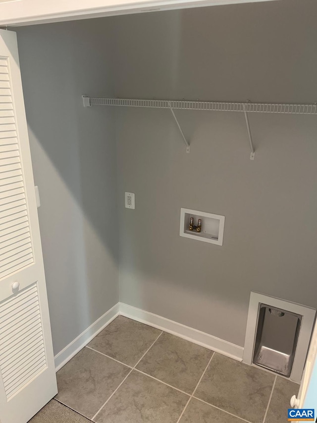 washroom with laundry area, washer hookup, baseboards, and tile patterned flooring
