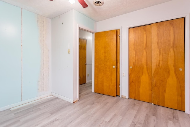 1627 Barbershop Rd, Edinburg, VA 22824 - unfurnished bedroom featuring a closet, a textured ceiling, ceiling fan, visible vents, and light wood-style floors