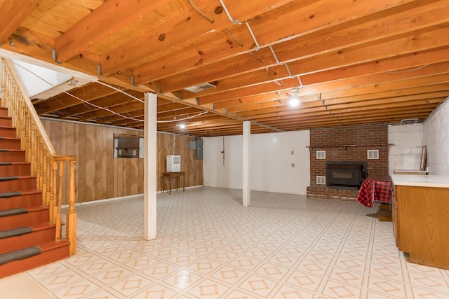 1627 Barbershop Rd, Edinburg, VA 22824 - finished basement with wood walls, visible vents, a brick fireplace, and stairs