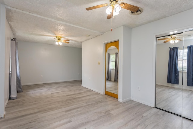 1627 Barbershop Rd, Edinburg, VA 22824 - spare room with arched walkways, ceiling fan, a textured ceiling, and wood finished floors