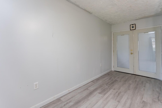 1627 Barbershop Rd, Edinburg, VA 22824 - foyer featuring baseboards, light wood-style floors, french doors, and a textured ceiling