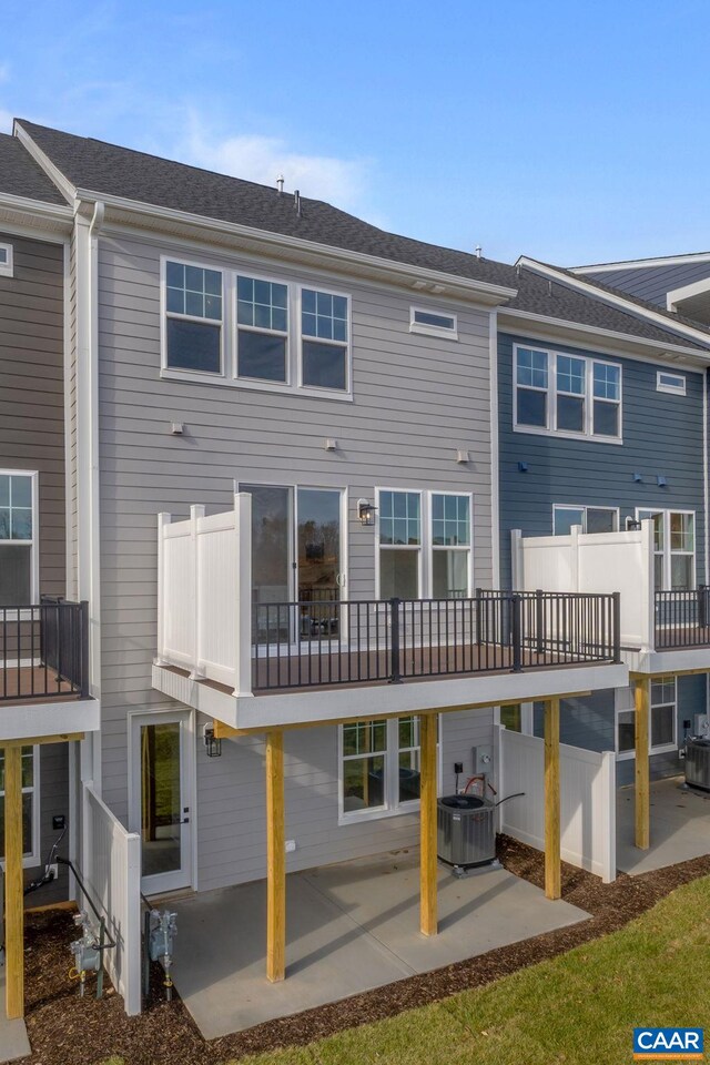 back of house with central AC unit and a patio