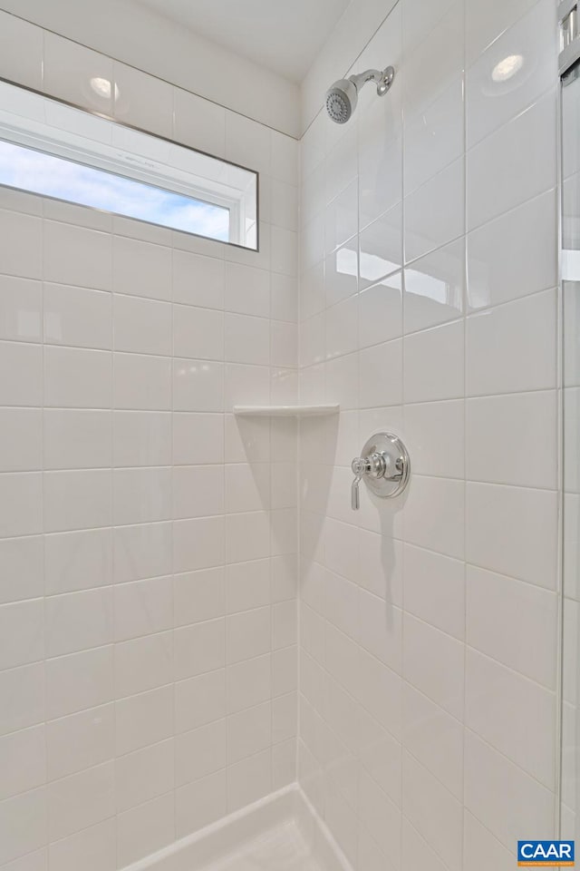 full bath featuring a tile shower