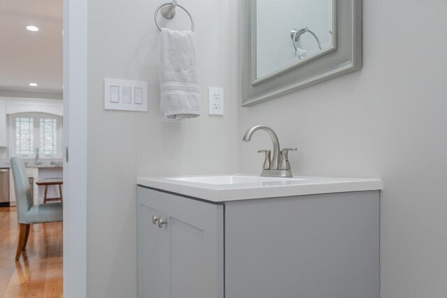 bathroom with hardwood / wood-style flooring and vanity