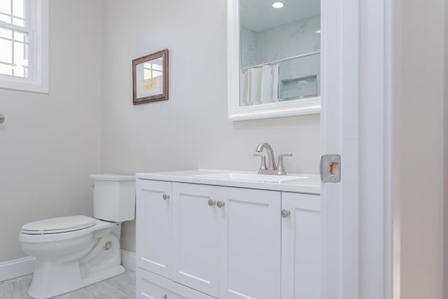 bathroom with vanity, toilet, and walk in shower