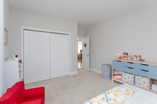 bedroom with a closet and light carpet