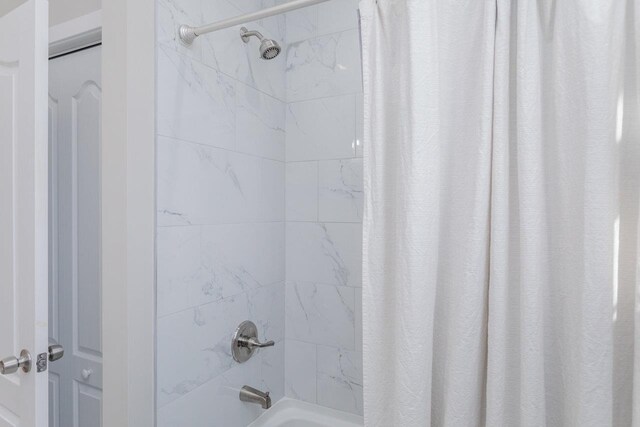 bathroom with shower / bathtub combination with curtain