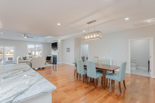 dining room featuring light hardwood / wood-style floors and ceiling fan