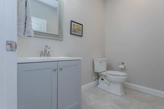 bathroom featuring vanity, tile patterned floors, and toilet