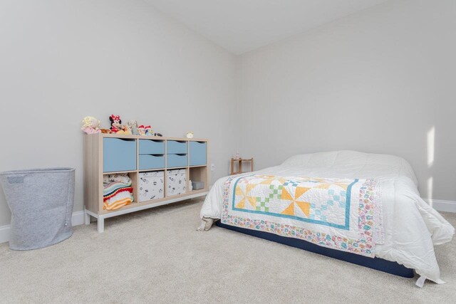 carpeted bedroom with vaulted ceiling