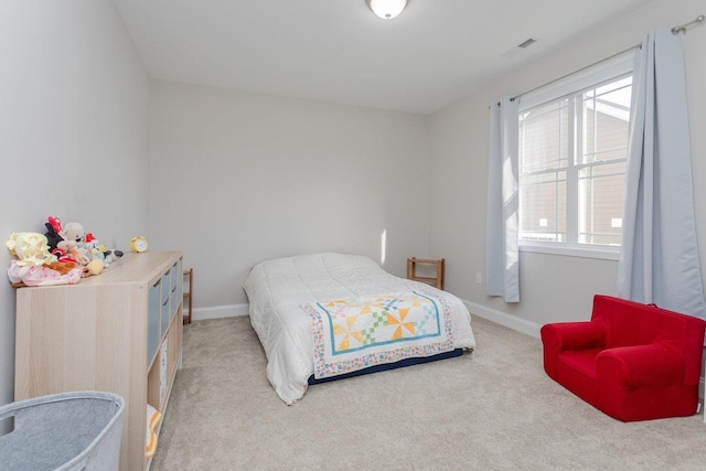 bedroom featuring light colored carpet