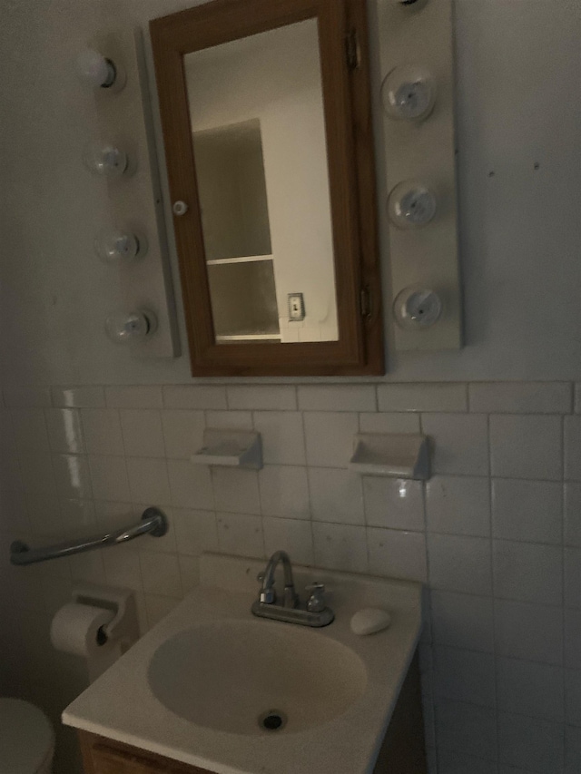 471 Gay St E, Harrisonburg, VA 22802 - bathroom with vanity, toilet, backsplash, and tile walls
