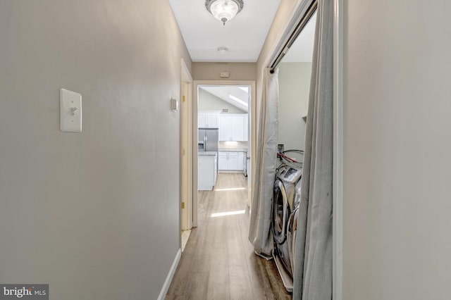  - corridor featuring baseboards and wood finished floors