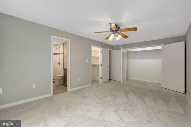  - unfurnished bedroom featuring carpet, connected bathroom, baseboards, and ceiling fan