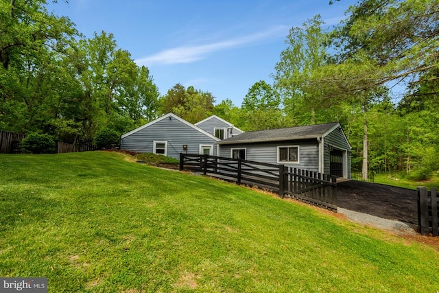  - back of property featuring a lawn and fence