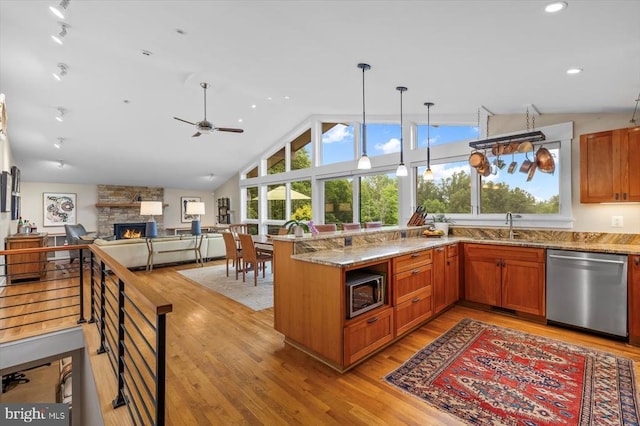103 Castleton Ford Rd, Castleton, VA 22716 - kitchen featuring appliances with stainless steel finishes, a stone fireplace, plenty of natural light, light stone countertops, and lofted ceiling