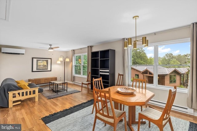 103 Castleton Ford Rd, Castleton, VA 22716 - dining space with an AC wall unit, baseboard heating, radiator heating unit, and light wood-style flooring