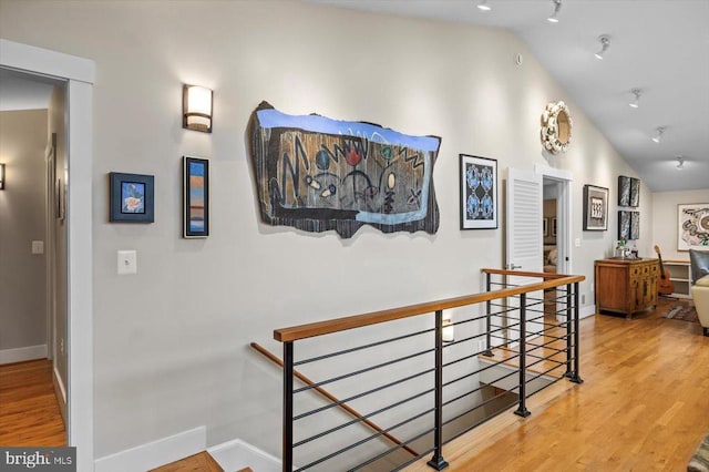 103 Castleton Ford Rd, Castleton, VA 22716 - hallway featuring an upstairs landing, vaulted ceiling, baseboards, and wood finished floors