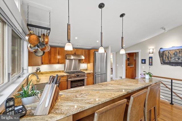 103 Castleton Ford Rd, Castleton, VA 22716 - kitchen featuring stainless steel appliances, under cabinet range hood, brown cabinets, light stone countertops, and recessed lighting