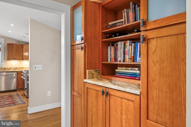 103 Castleton Ford Rd, Castleton, VA 22716 - detailed view of stainless steel appliances, light wood finished floors, open shelves, brown cabinets, and baseboards