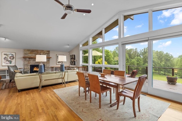 103 Castleton Ford Rd, Castleton, VA 22716 - dining area with high vaulted ceiling, a fireplace, a ceiling fan, and light wood finished floors